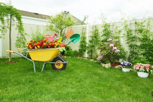 Local gardener pruning shrubs and shaping plants in North Sheen